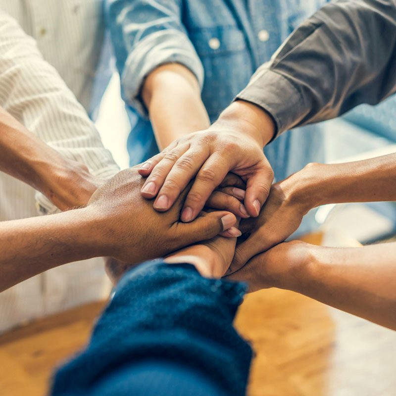 Team members joining hands